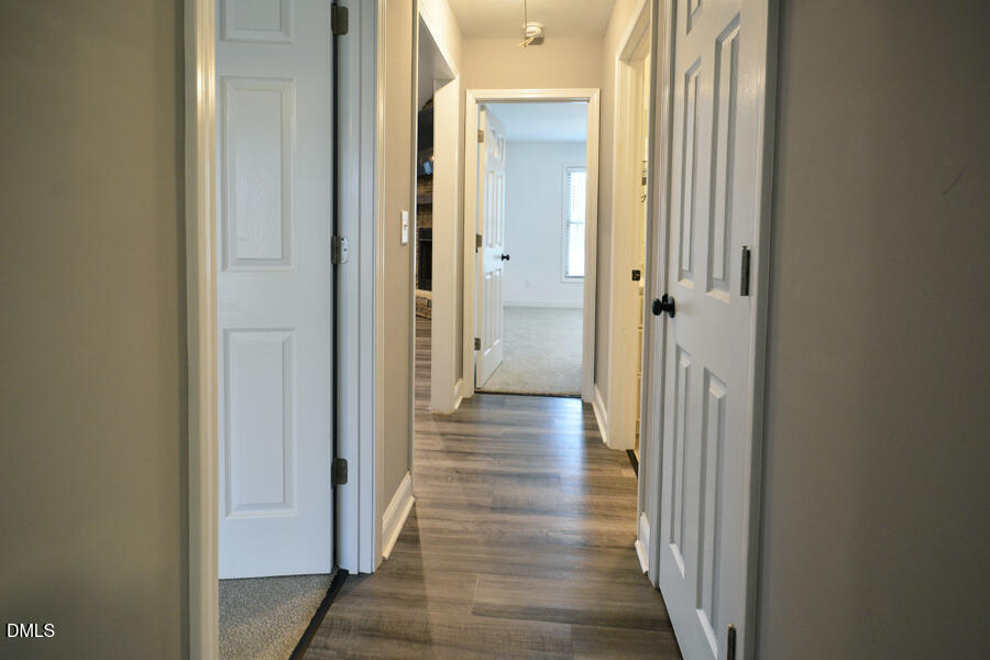 3082 East Thollie Green Road Stem, NC 27581 - Photo 35 of 45 a view of a hallway with wooden floor