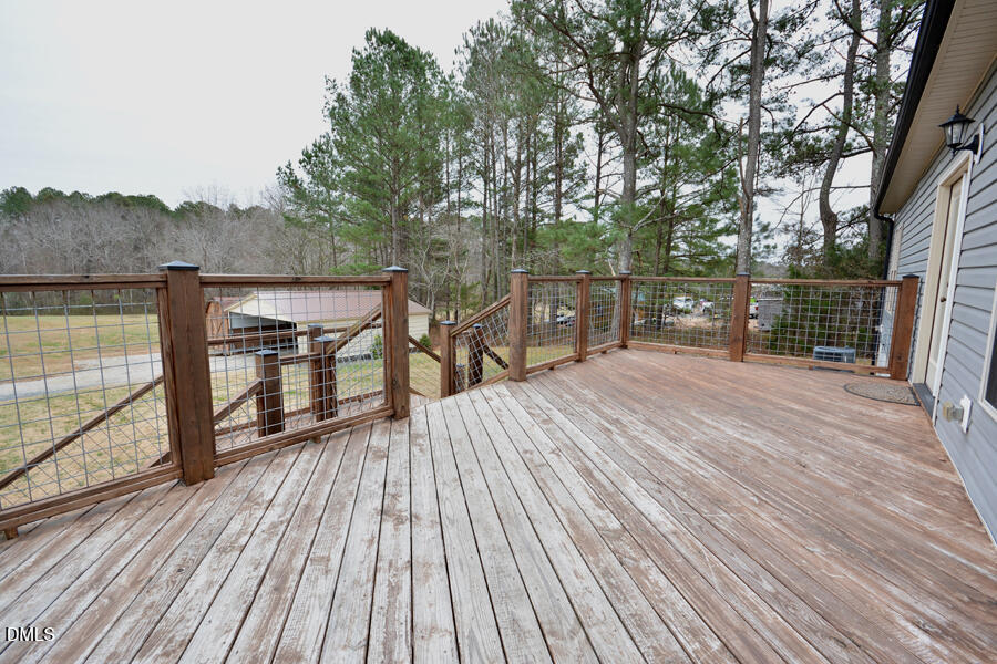 3082 East Thollie Green Road Stem, NC 27581 - Photo 38 of 45 a view of balcony with deck and wooden floor