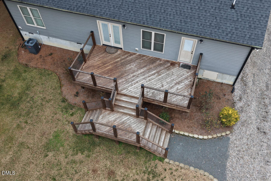 3082 East Thollie Green Road Stem, NC 27581 - Photo 39 of 45 a roof deck with a table and a barbeque