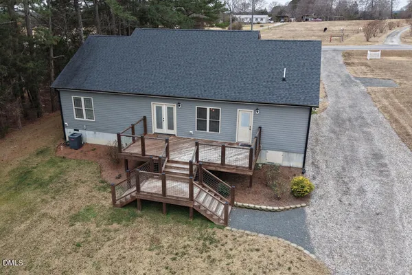 a view of a house with a yard and sitting area