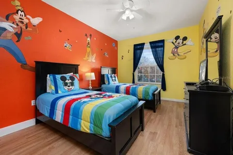 a bedroom with bed and wooden floor