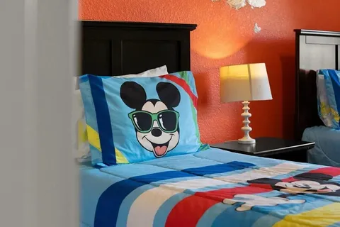 a bedroom with a bed and painting on the wall