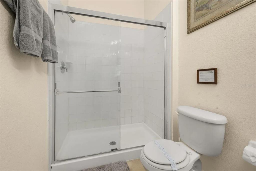 7664 Comrow Street, Unit 302 Kissimmee, FL 34747 - Photo 14 of 19 a white toilet next to a bathroom