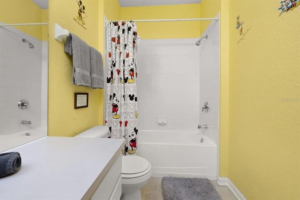 7664 Comrow Street, Unit 302 Kissimmee, FL 34747 - Photo 10 of 19 a bathroom with a sink a toilet and shower