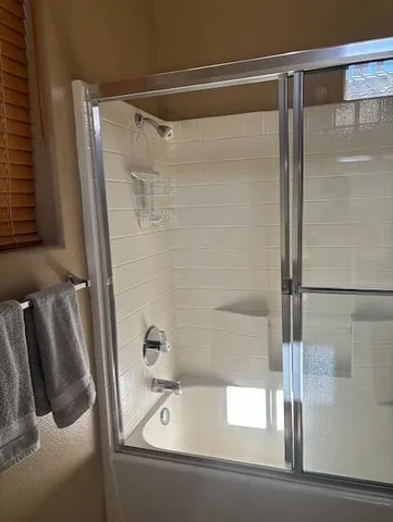 a bathroom with a shower and a tub
