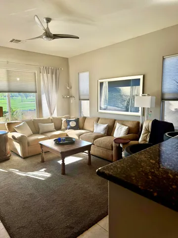 a living room with furniture and a large window