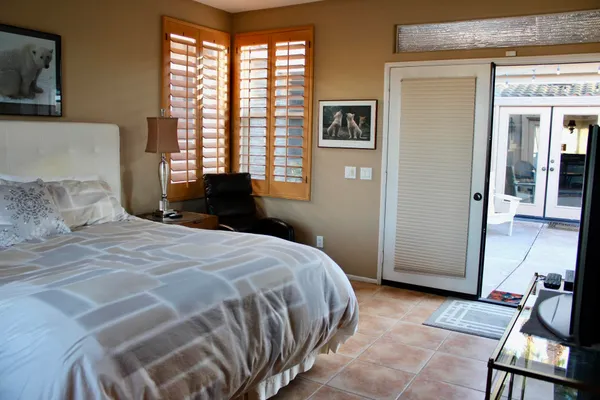 a view of a hallway with workspace and a window