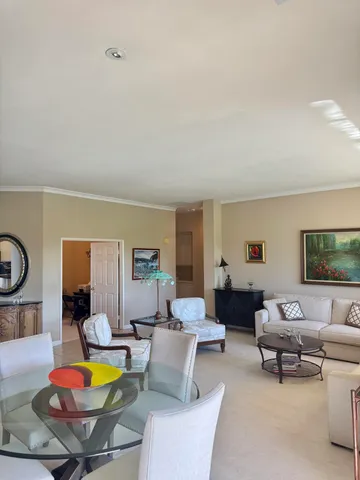 a living room with furniture a flat screen tv and a window