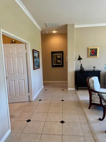 a view of a hallway with workspace and a window