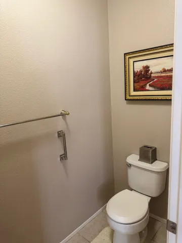 a white toilet sitting next to a small bathroom