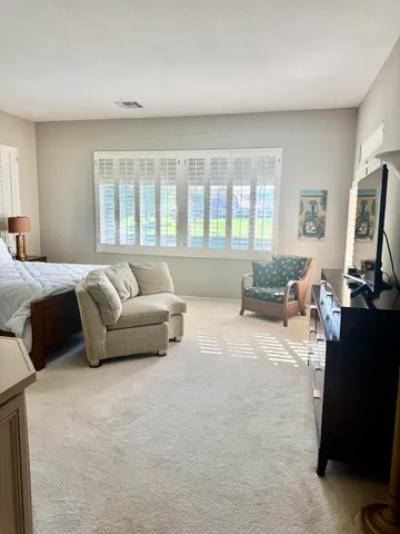 a bedroom with furniture and a flat screen tv