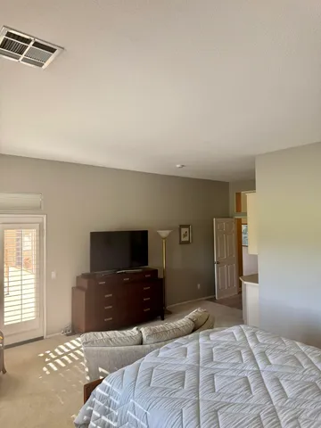 a bedroom with a bed and a television