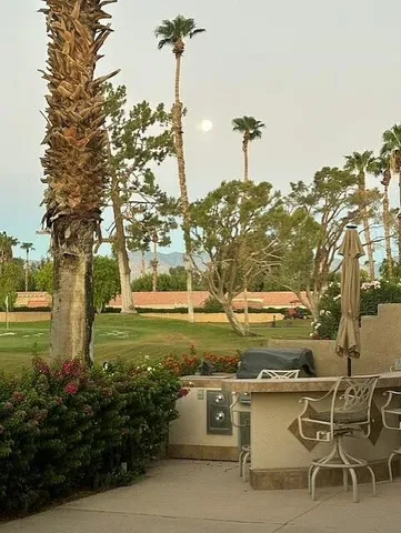 a view of a yard with an outdoor seating