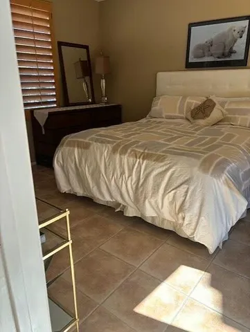 a bedroom with a bed and window