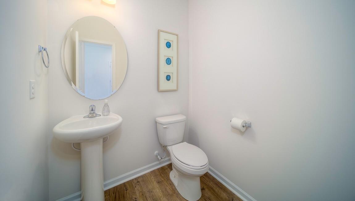 1240 Secrest Cmns Drive Monroe, NC 28112 - Photo 17 of 39 a bathroom with a toilet a sink and mirror
