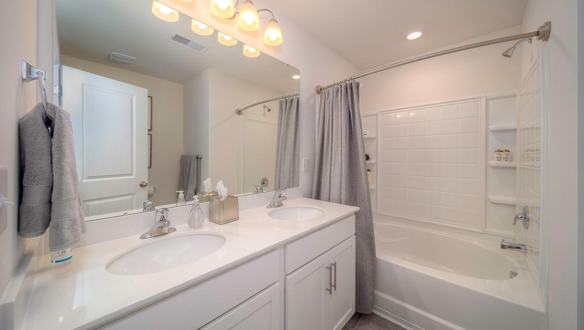 1240 Secrest Cmns Drive Monroe, NC 28112 - Photo 31 of 39 a bathroom with a granite countertop sink mirror and a bathtub