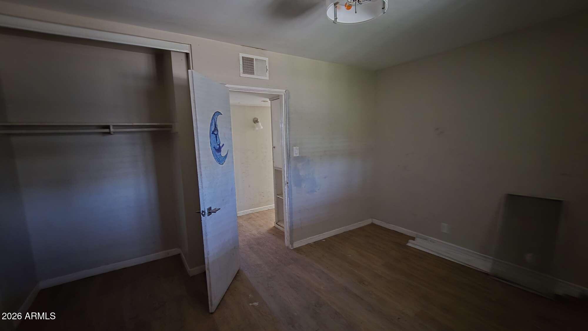 834 West Osborn Road Phoenix, AZ 85013 - Photo 32 of 45 an empty room with wooden floor and closet
