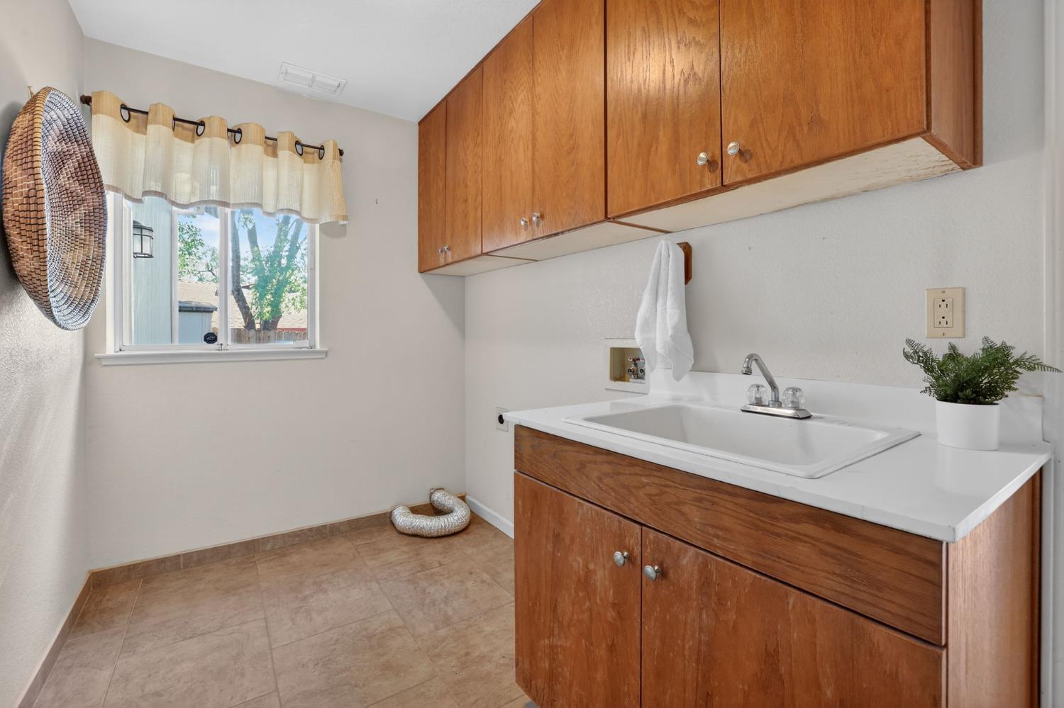 2560 Solano Road Cameron Park, CA 95682 - Photo 31 of 67 Huge laundry room with sink and storage cabinets on main level