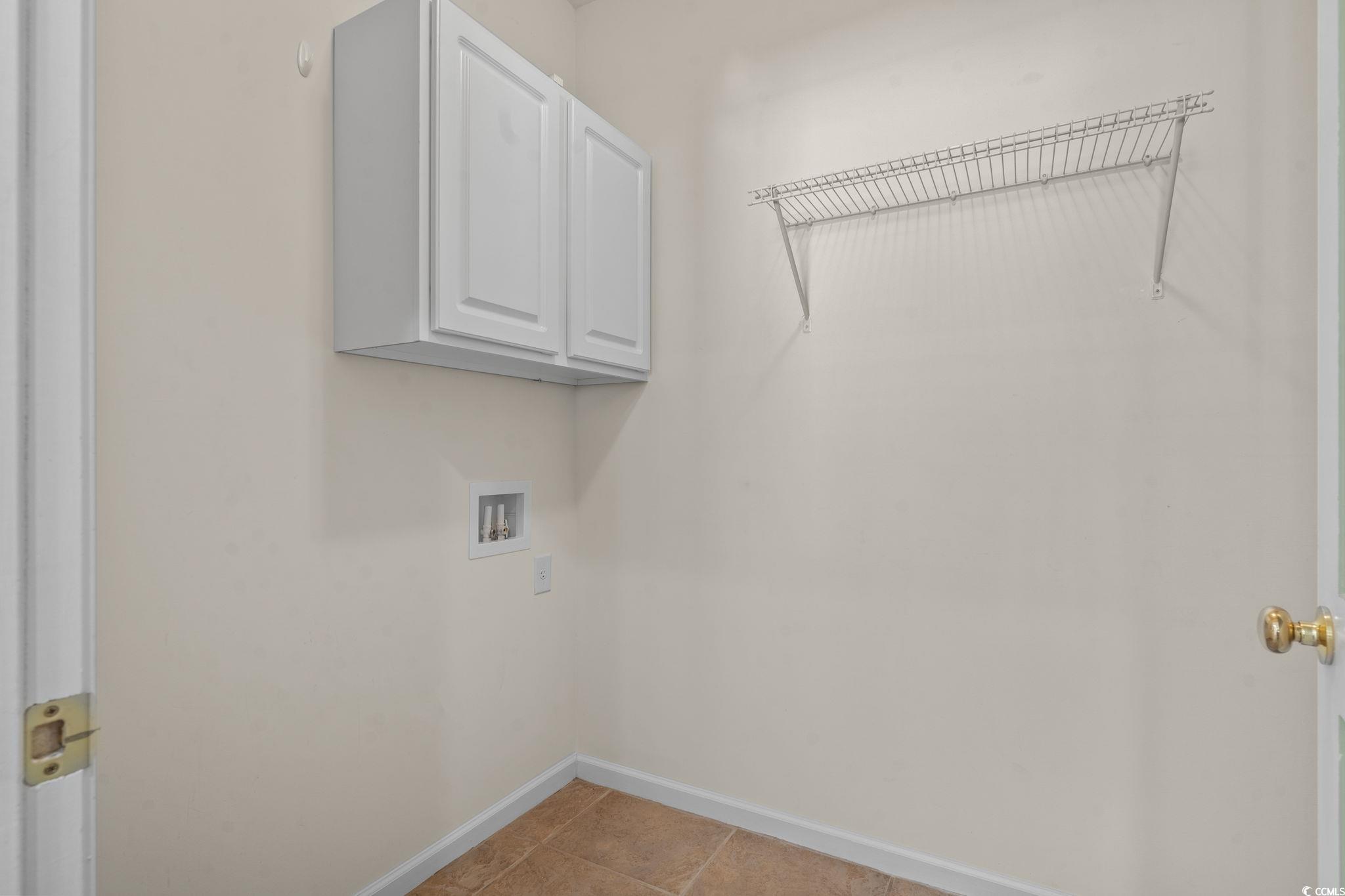 237 Moonglow Circle, Unit 102 Murrells Inlet, SC 29576 - Photo 11 of 35 Washroom featuring cabinet space, light tile patterned floors, and washer hookup