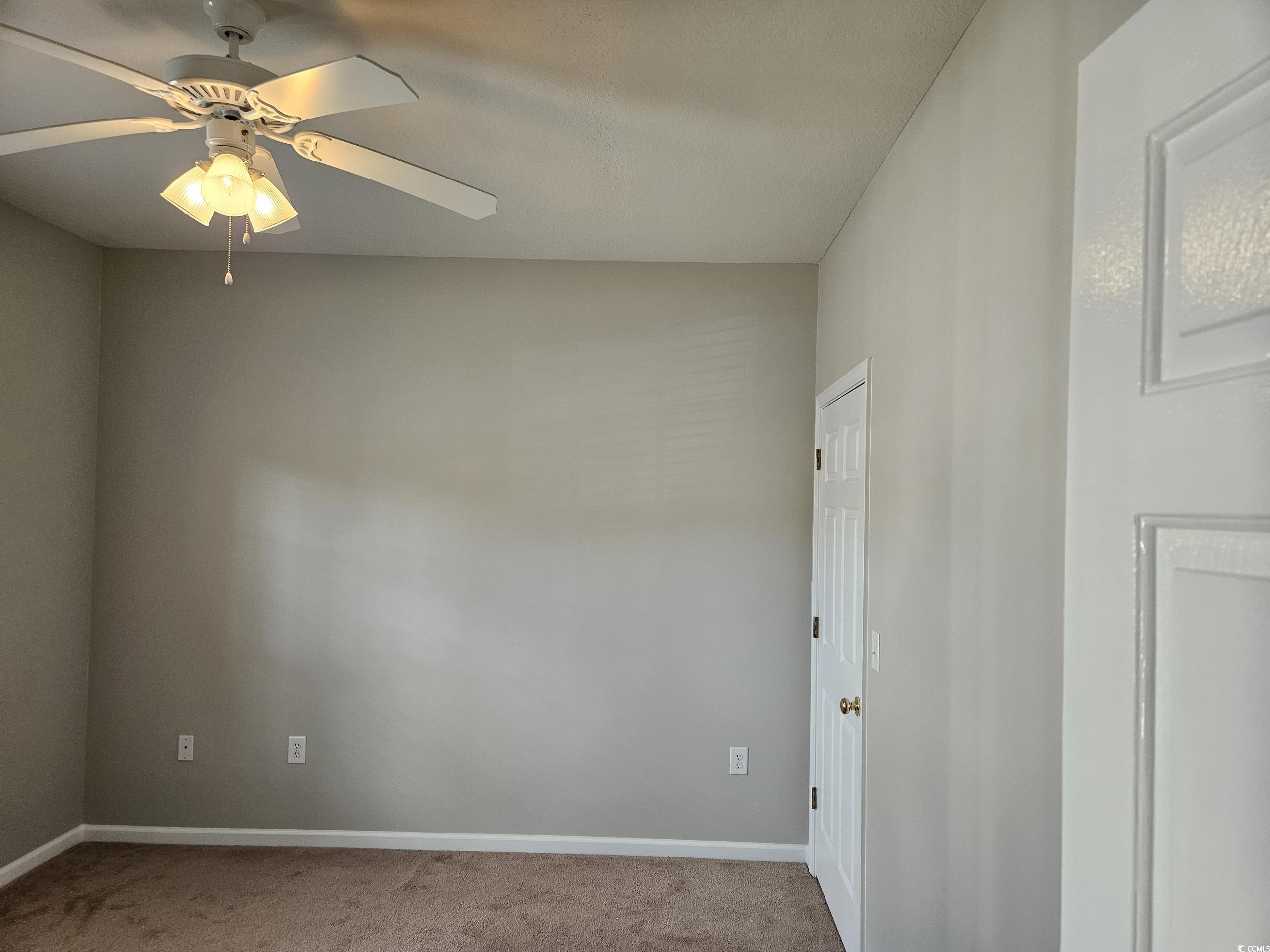 237 Moonglow Circle, Unit 102 Murrells Inlet, SC 29576 - Photo 19 of 35 Empty room featuring light colored carpet and ceiling fan