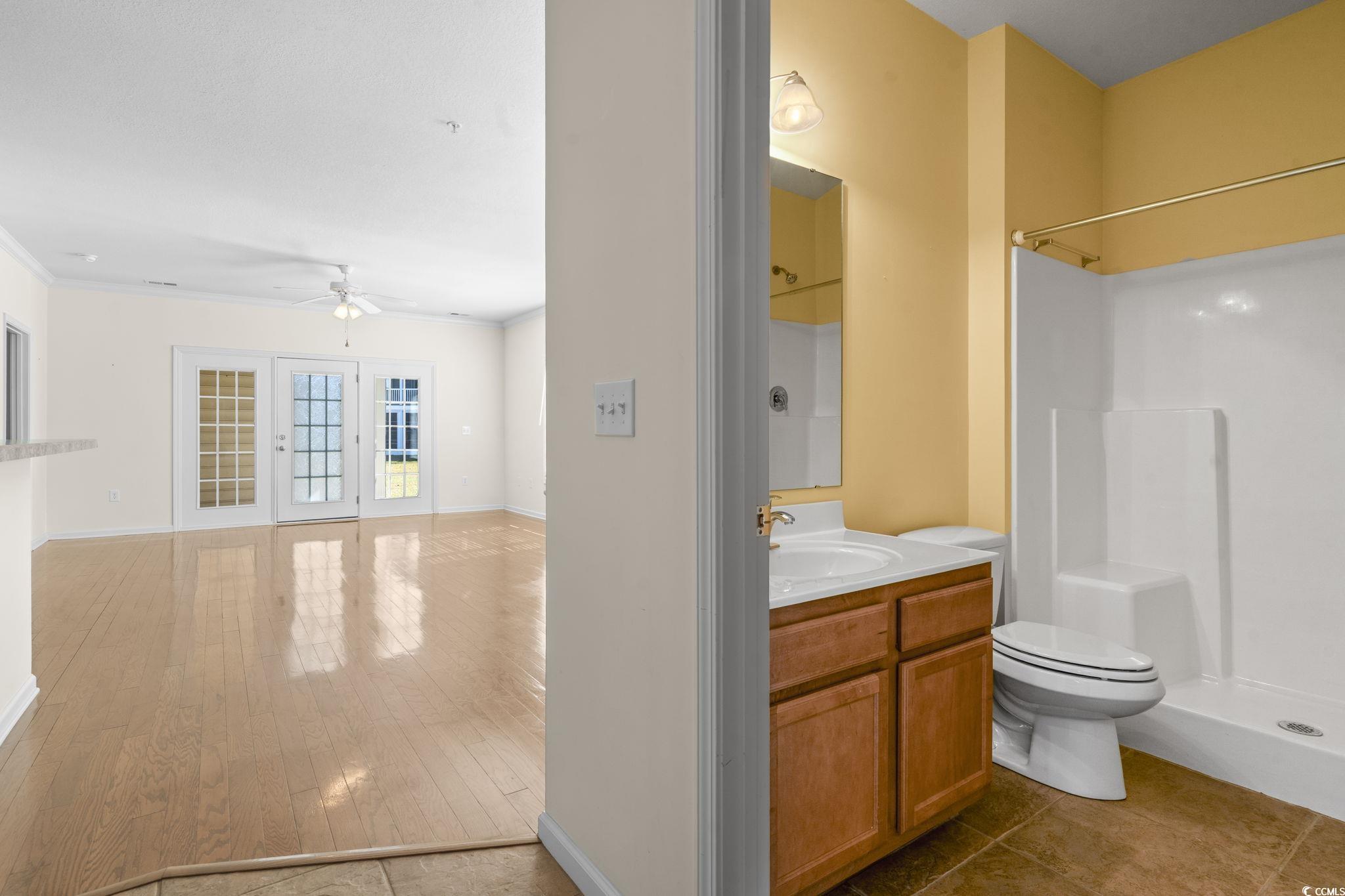 237 Moonglow Circle, Unit 102 Murrells Inlet, SC 29576 - Photo 21 of 35 Full bathroom with vanity, a shower, ceiling fan, crown molding, and dark wood-style flooring