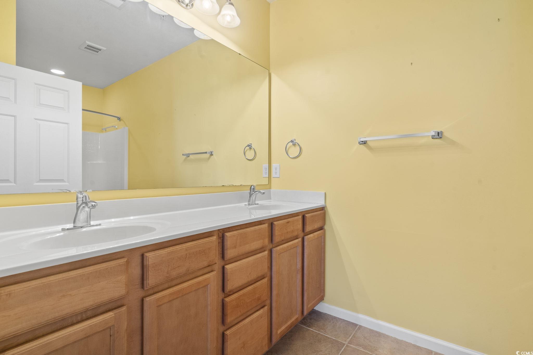 237 Moonglow Circle, Unit 102 Murrells Inlet, SC 29576 - Photo 28 of 35 Bathroom with double vanity, light tile patterned floors, and a shower