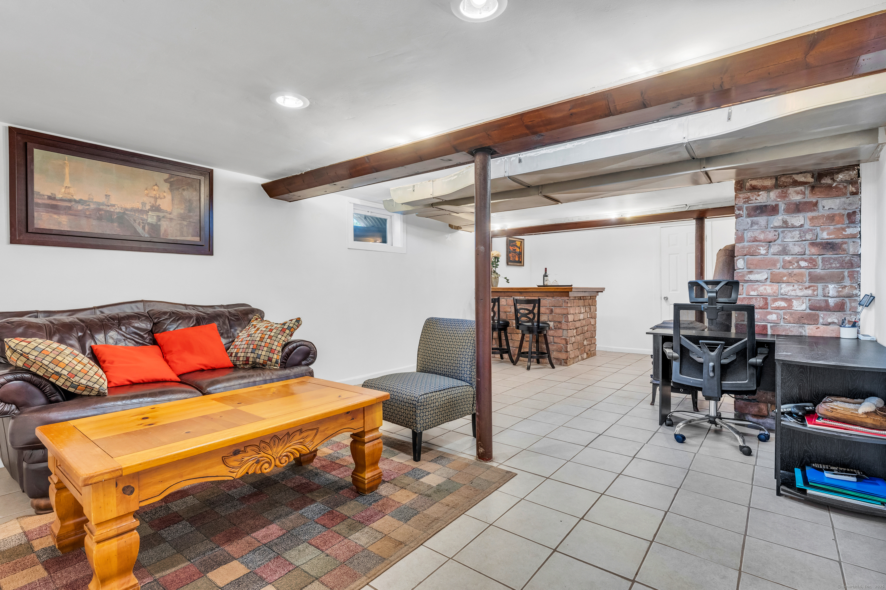 64 Dohm Avenue Guilford, CT 06437 - Photo 29 of 38 Basement has a bar set up and wood stove