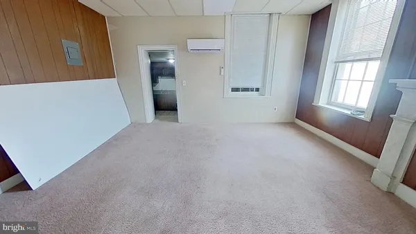 an empty room with windows and closet