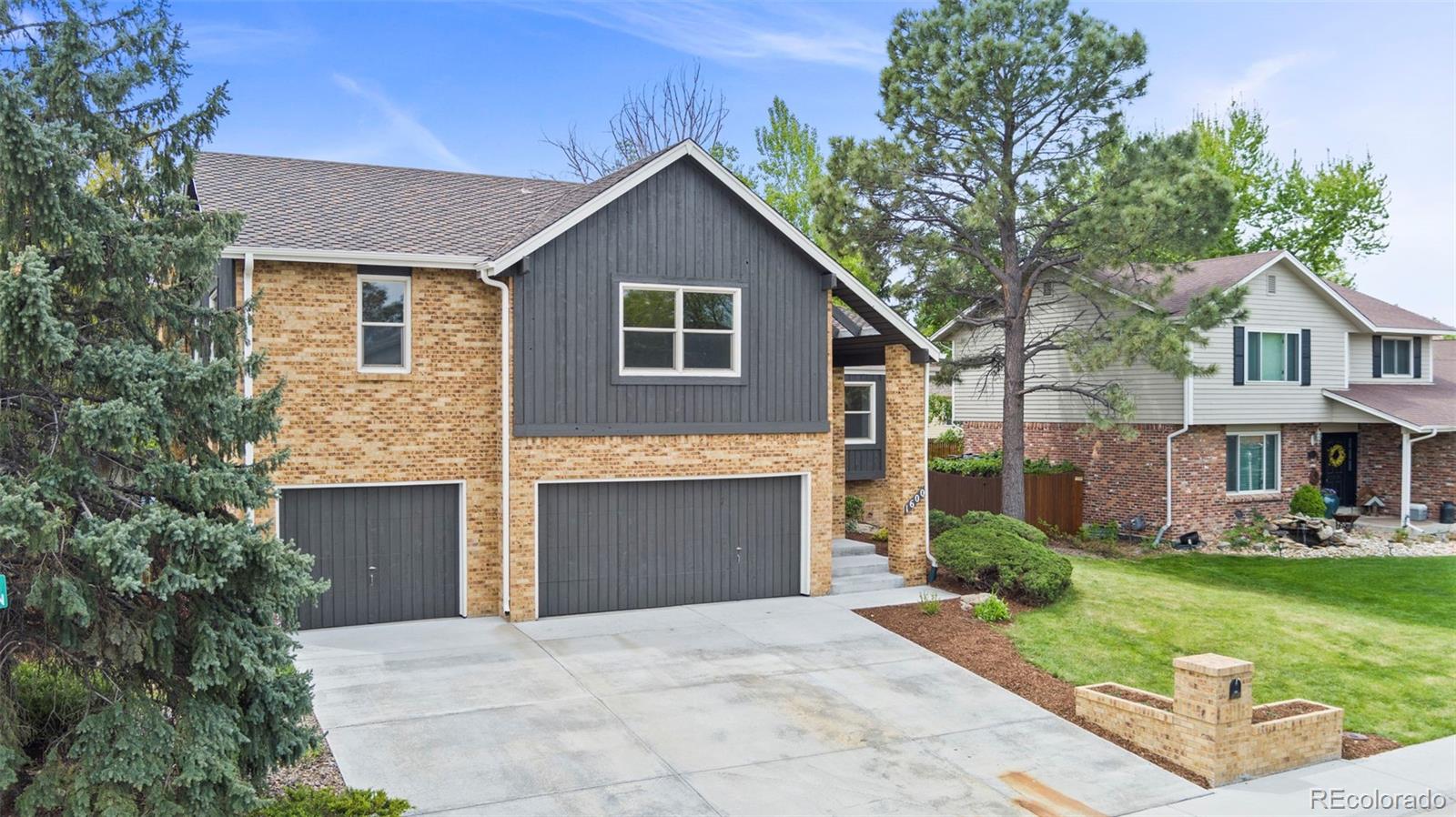 1600 West 113th Avenue Westminster, CO 80234 - Photo 1 of 2 a front view of a house with a garden and yard
