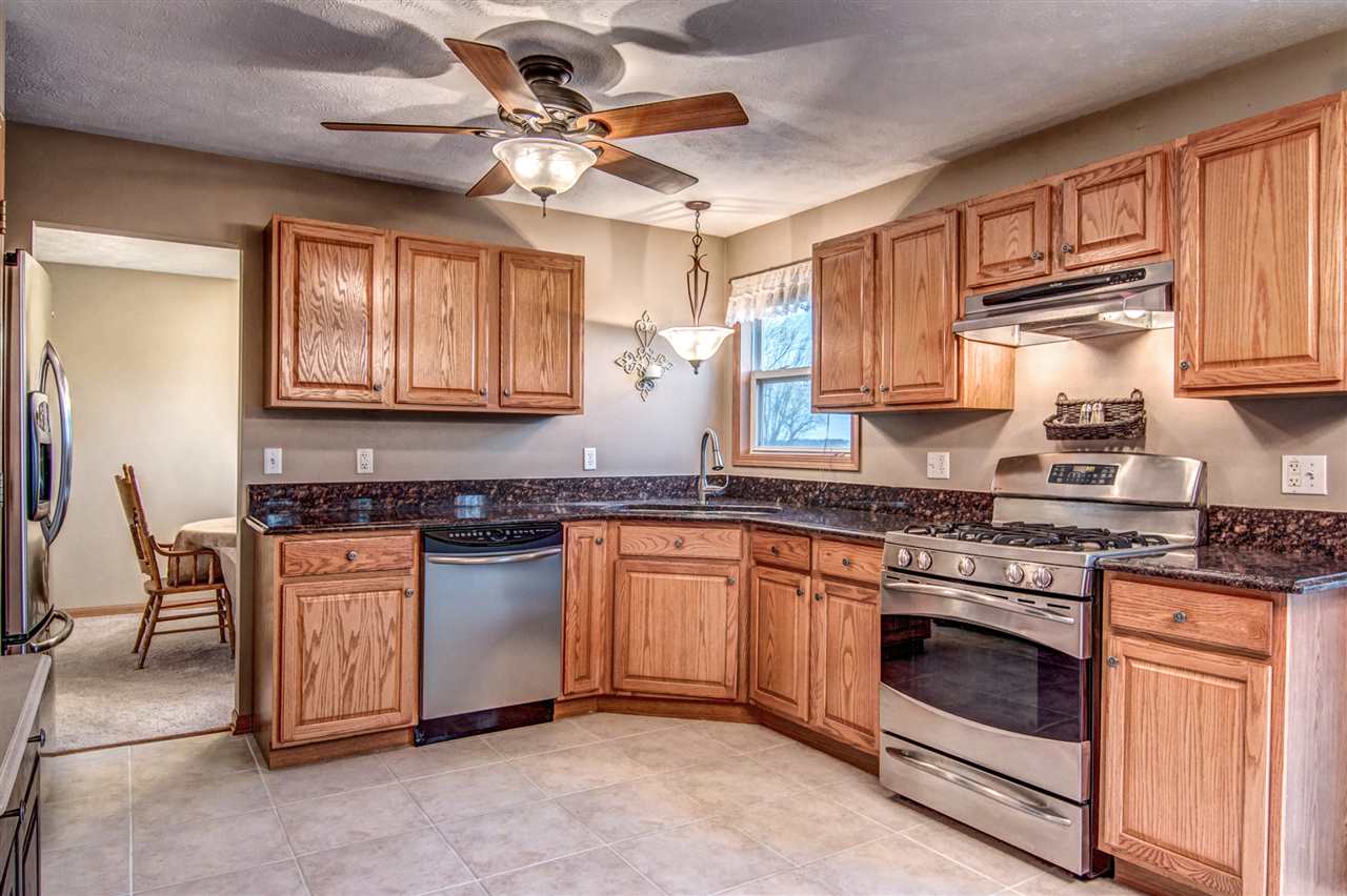 9430 Edson Road Capron, IL 61012 - Photo 5 of 25 a kitchen with stainless steel appliances granite countertop a stove and a sink