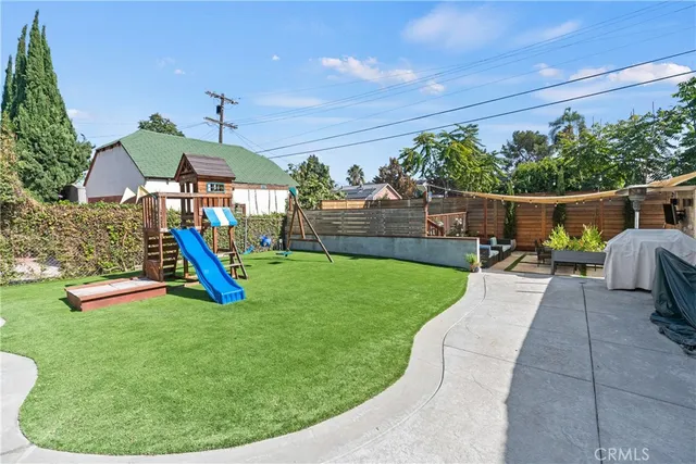 a view of a backyard with swimming pool