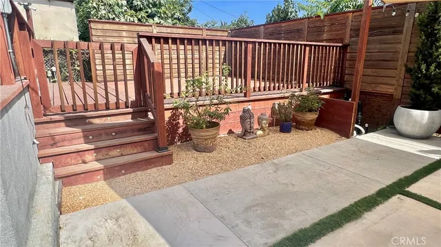 a view of balcony with wooden floor and fence