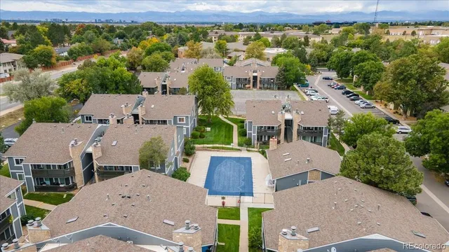 an aerial view of residential houses with outdoor space and parking