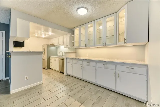 a kitchen with cabinets a sink and appliances