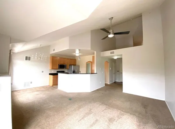 a view of a room with a kitchen