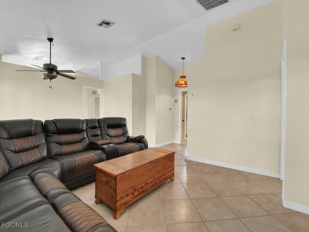 4370 20th Street Northeast Naples, FL 34120 - Photo 11 of 35 a living room with furniture and a ceiling fan