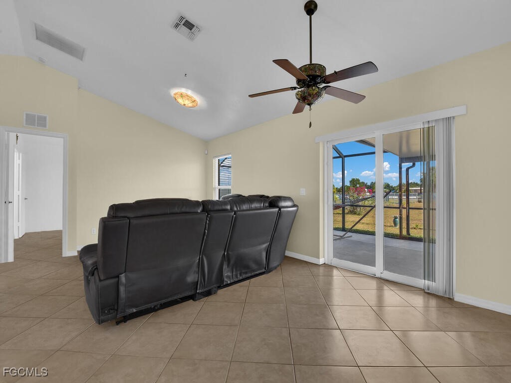 4370 20th Street Northeast Naples, FL 34120 - Photo 13 of 35 a living room with a couch and a ceiling fan