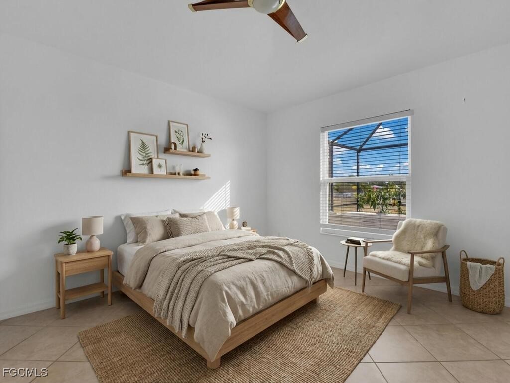 4370 20th Street Northeast Naples, FL 34120 - Photo 15 of 35 a bedroom with a bed and a chair