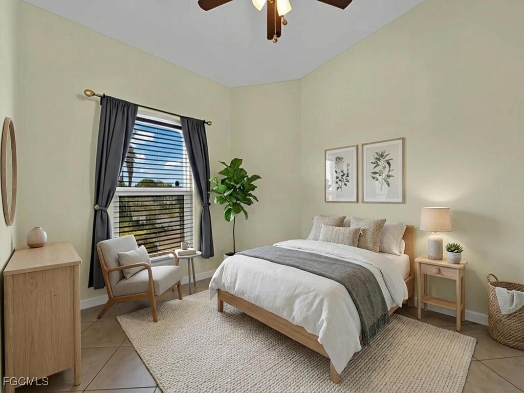 4370 20th Street Northeast Naples, FL 34120 - Photo 20 of 35 a bedroom with a bed and chair