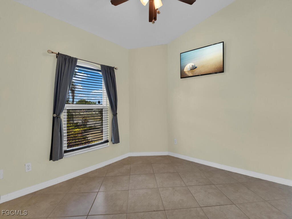 4370 20th Street Northeast Naples, FL 34120 - Photo 21 of 35 an empty room with windows and fan