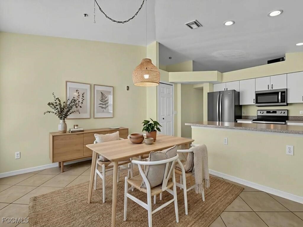 4370 20th Street Northeast Naples, FL 34120 - Photo 4 of 35 a view of a dining room with furniture and a kitchen