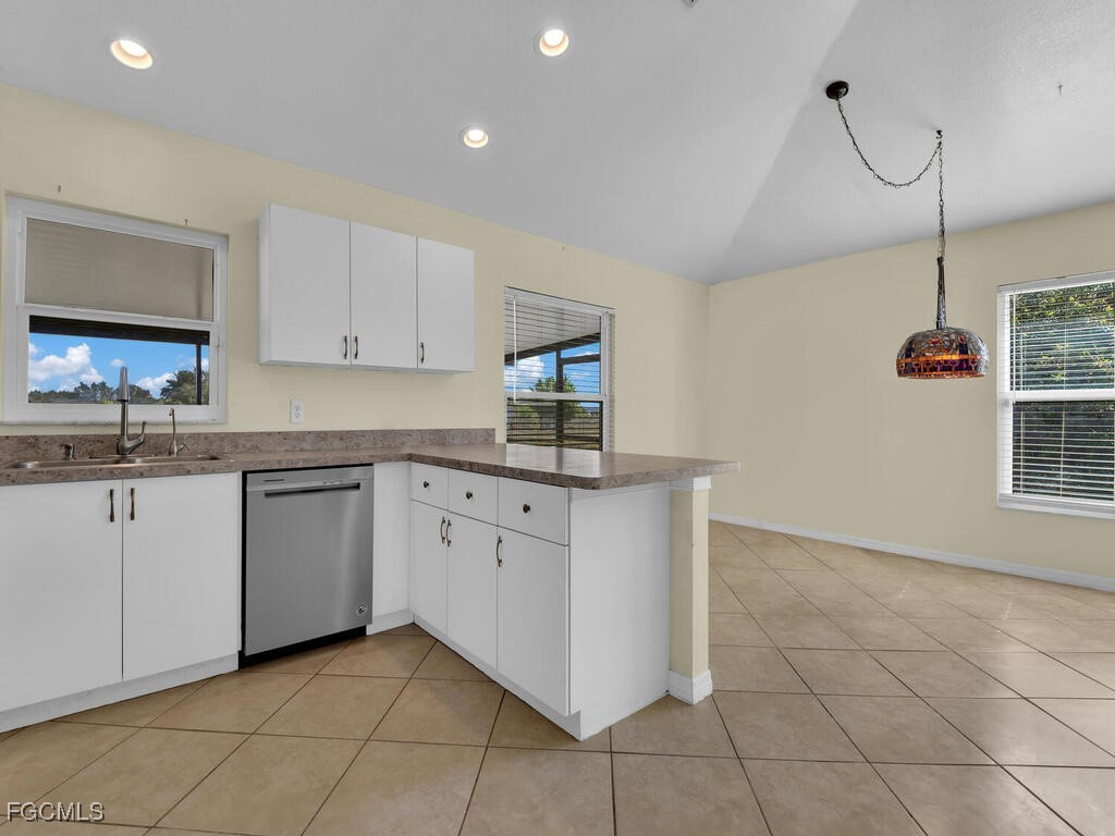 4370 20th Street Northeast Naples, FL 34120 - Photo 7 of 35 a kitchen with cabinets and window