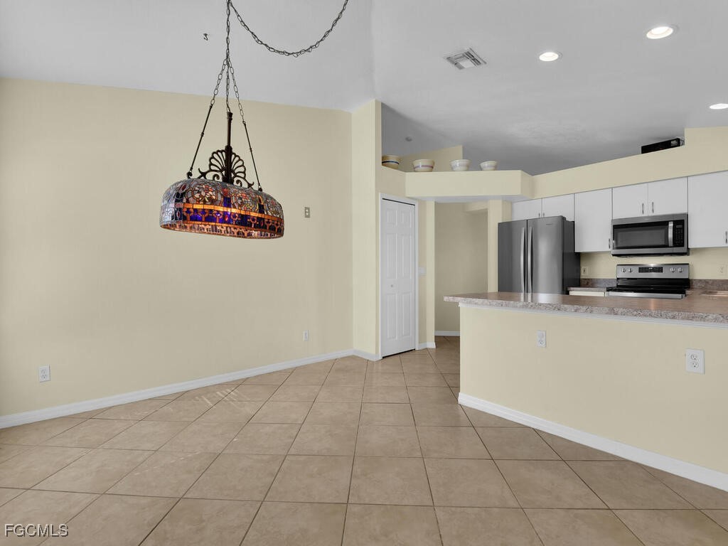 4370 20th Street Northeast Naples, FL 34120 - Photo 9 of 35 a view of a kitchen with a sink wooden floor and a chandelier