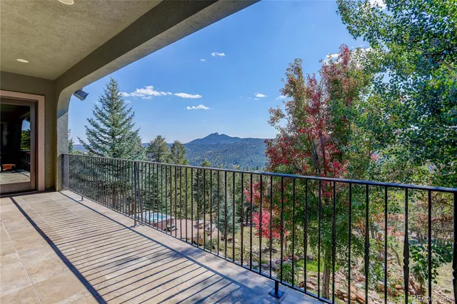 a balcony with trees in front of it