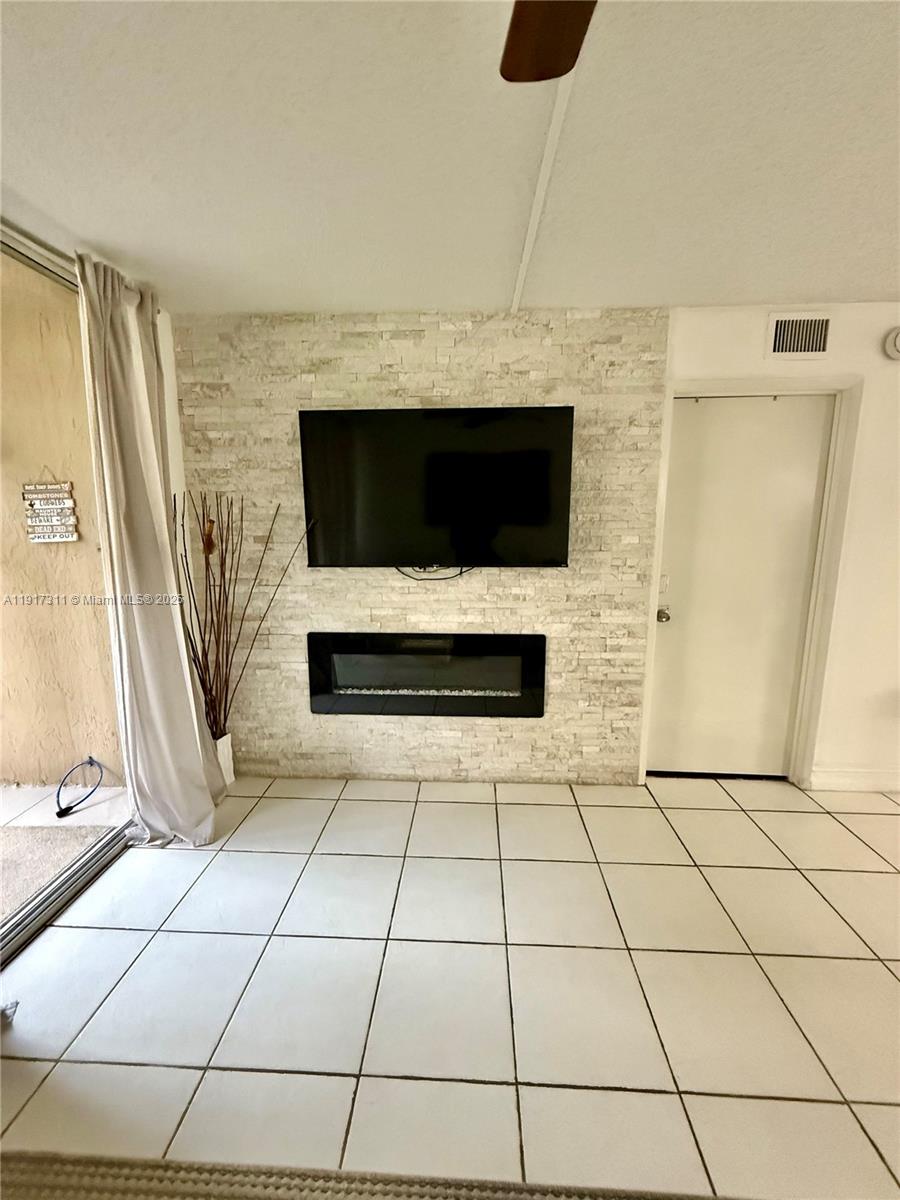 8246 Northwest 24th Street, Unit 8246 Coral Springs, FL 33065 - Photo 12 of 27 a view of a livingroom with an empty space and a fireplace