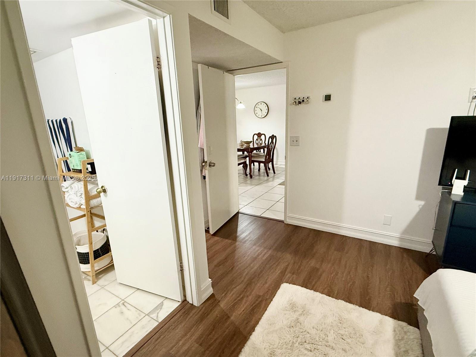 8246 Northwest 24th Street, Unit 8246 Coral Springs, FL 33065 - Photo 13 of 27 a view of a hallway with wooden floor and staircase
