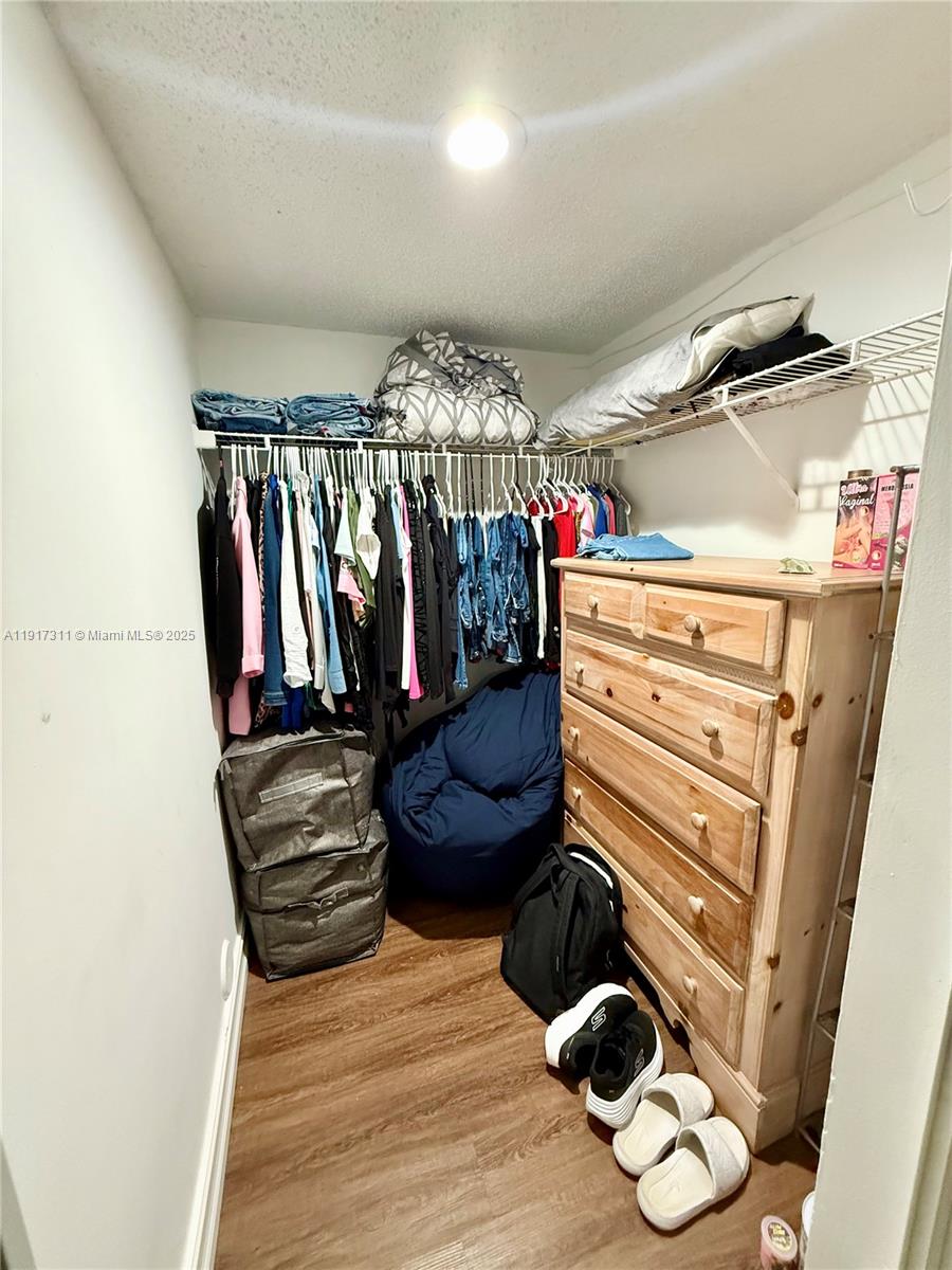 8246 Northwest 24th Street, Unit 8246 Coral Springs, FL 33065 - Photo 18 of 27 a view of walk in closet with clothes and shoes