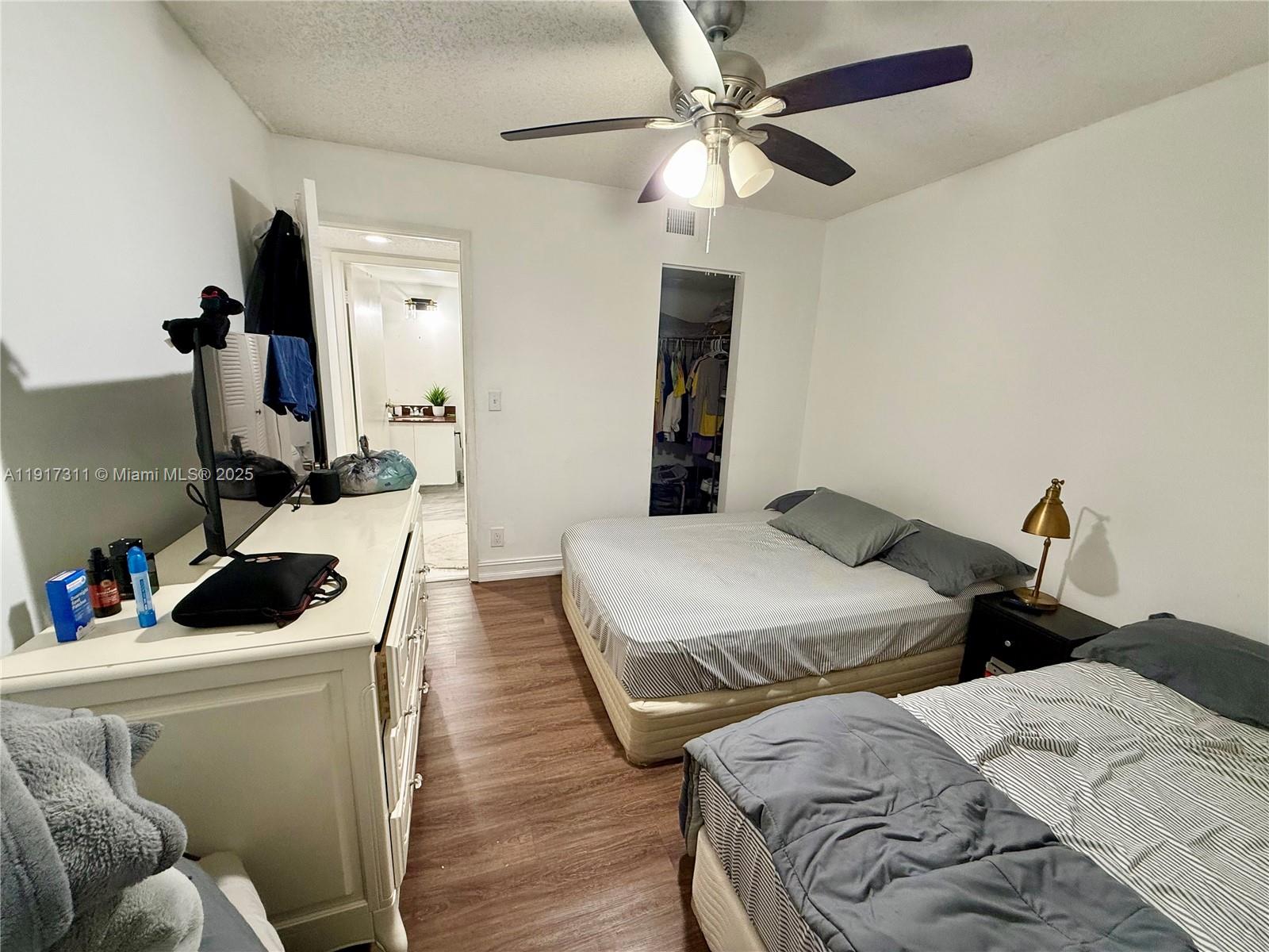 8246 Northwest 24th Street, Unit 8246 Coral Springs, FL 33065 - Photo 19 of 27 a bedroom with two beds and a couch