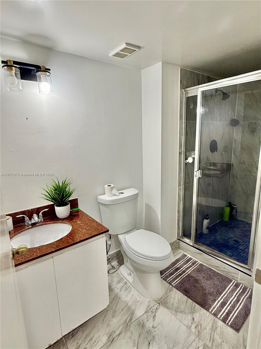 8246 Northwest 24th Street, Unit 8246 Coral Springs, FL 33065 - Photo 21 of 27 a bath room with a toilet a sink and a shower