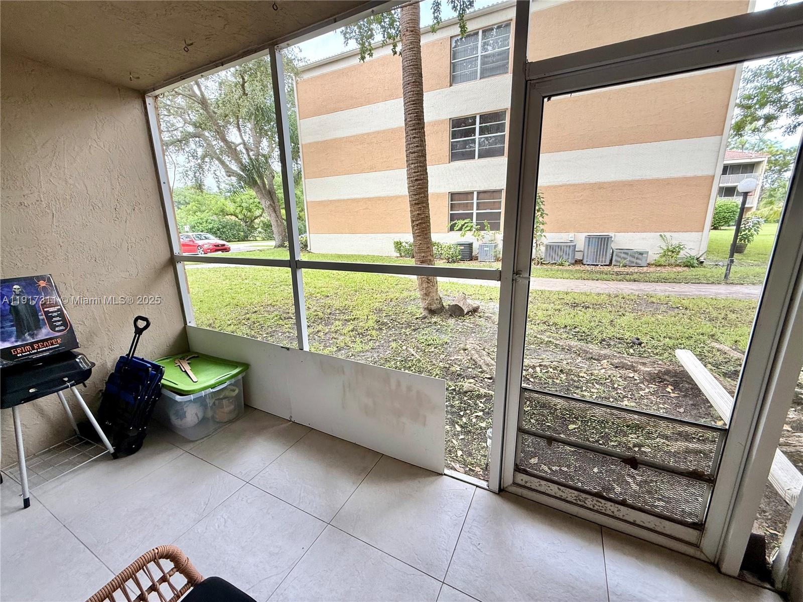 8246 Northwest 24th Street, Unit 8246 Coral Springs, FL 33065 - Photo 24 of 27 a view of a porch with furniture and a yard